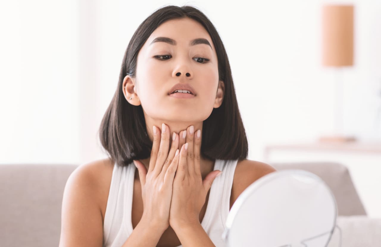 woman touching her neck