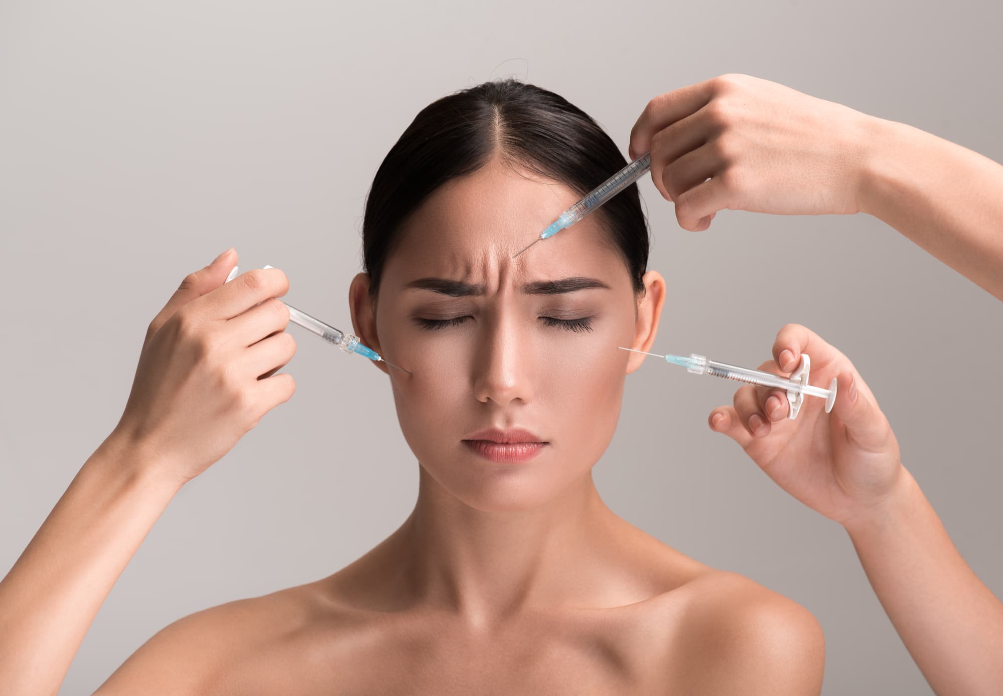 woman getting multiple botox injection in frown lines