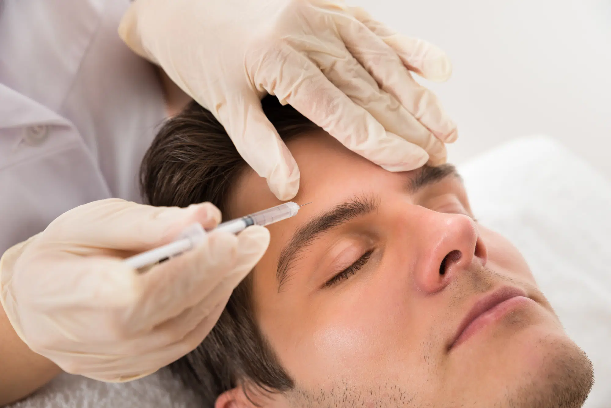 male patient getting forehead fillers