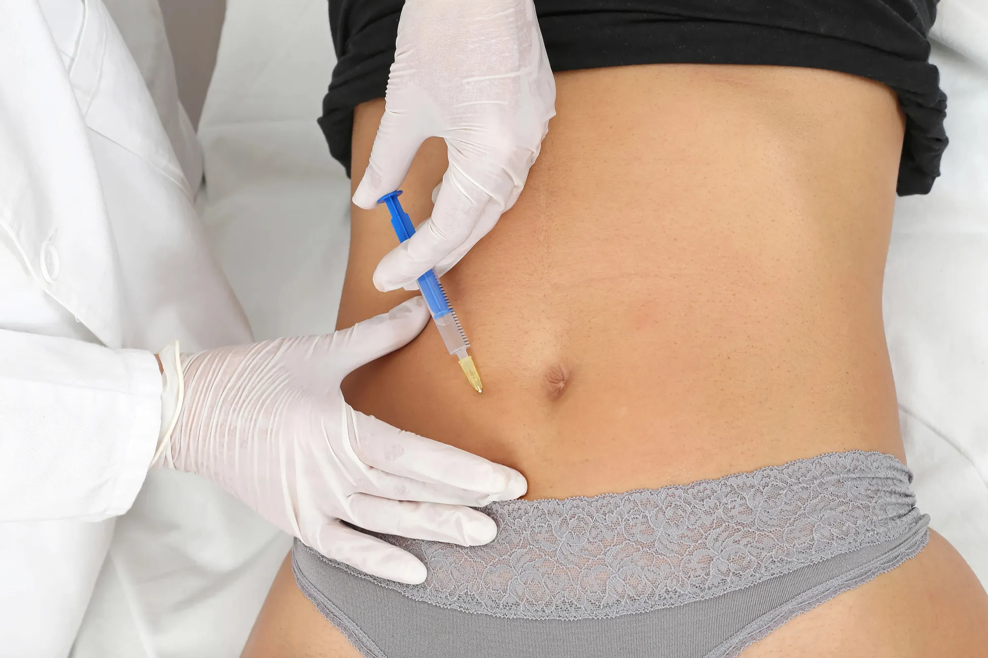 female patient getting botox in the stomach