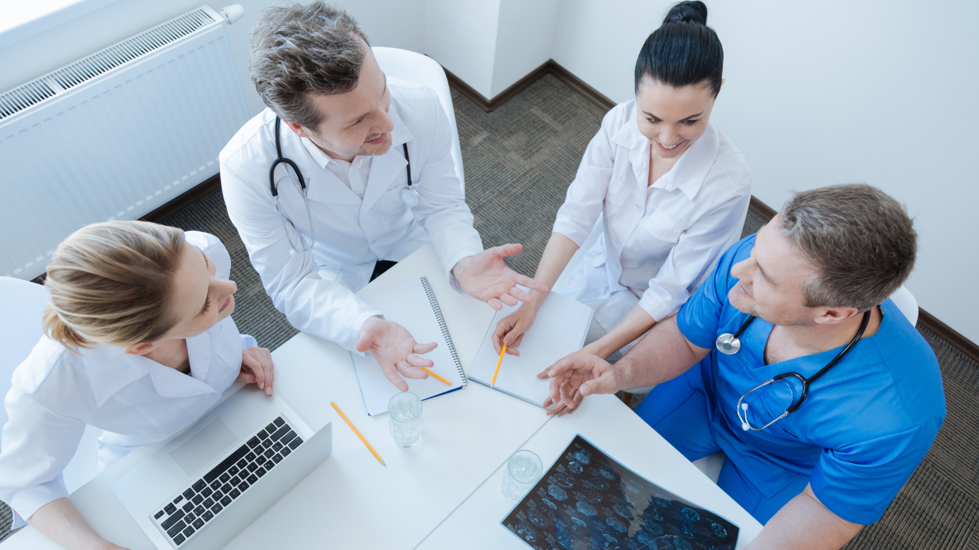 Medical professionals meeting with each other.