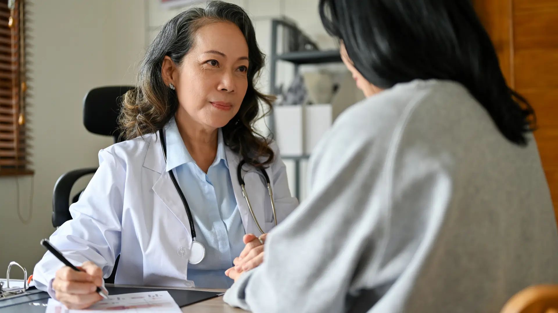 A medical professional talking to a patient.