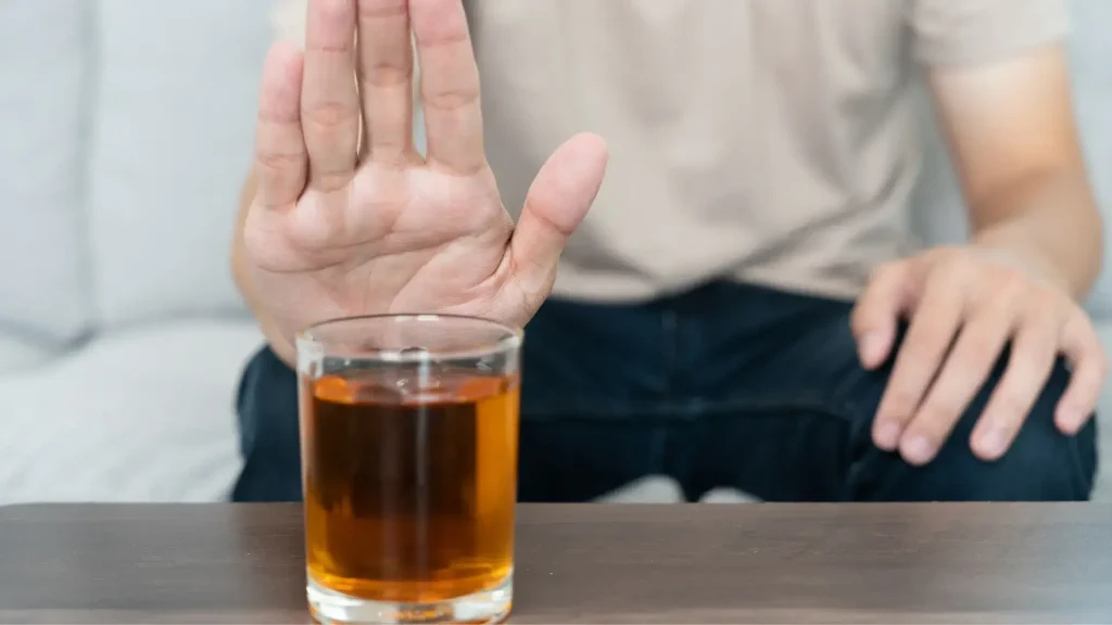 An individual avoiding alcohol consumption.