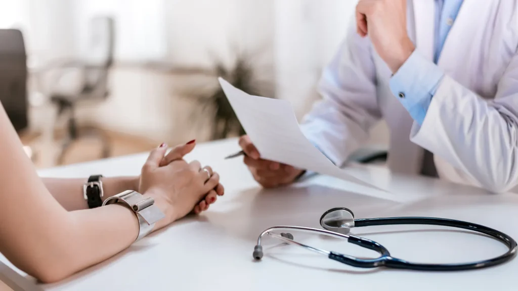 An individual consulting a medical professional before treatment.