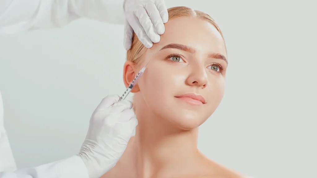 A medical professional administering an injection into a patient's face.