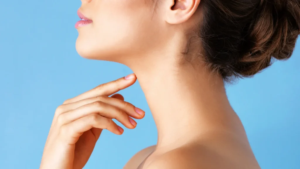 An individual flexing their firmer and smoother neck area.