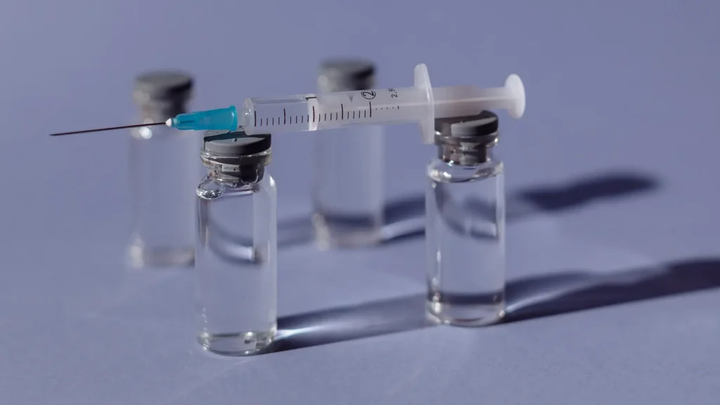 A close-up shot of several vials and injection.