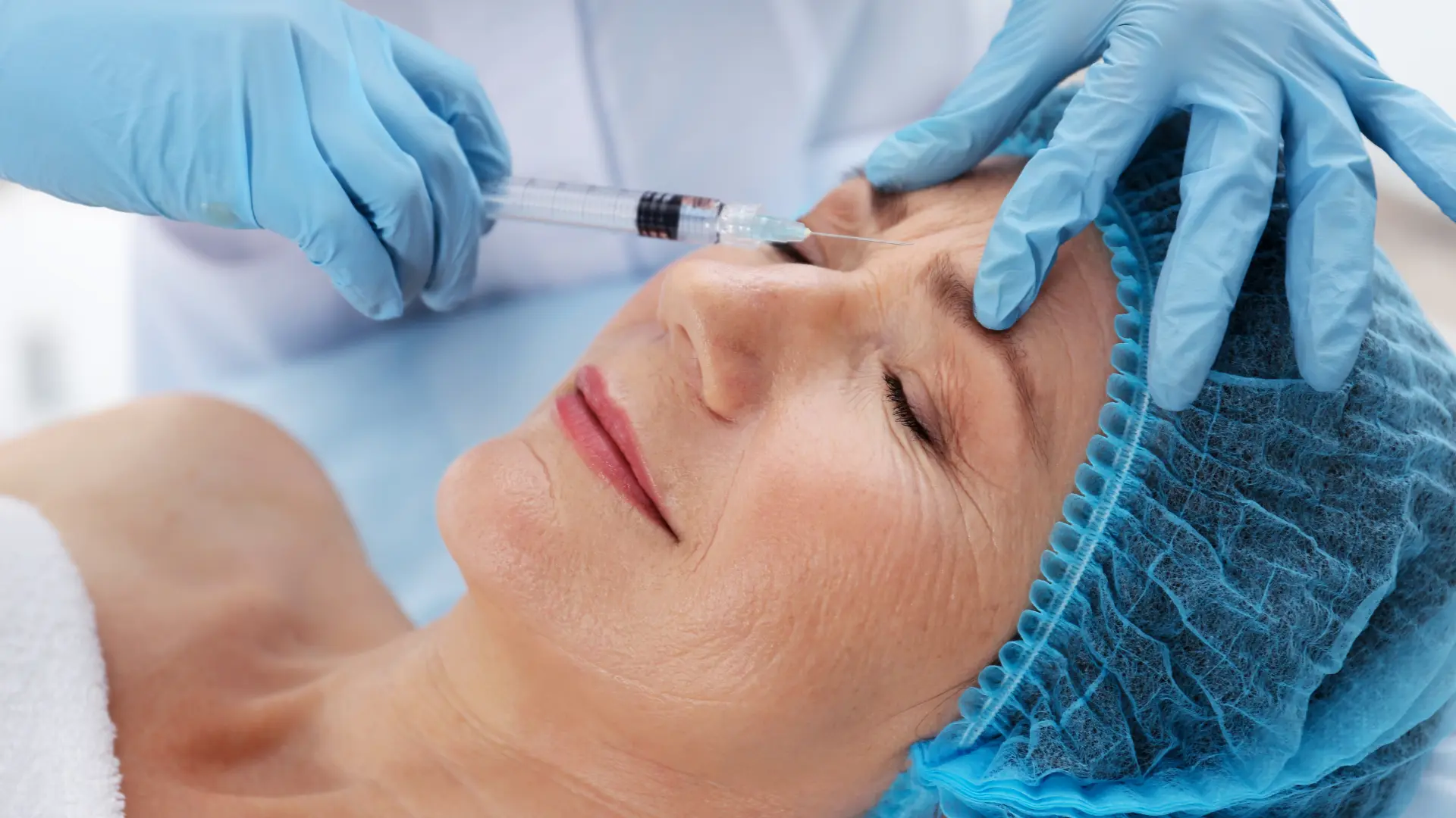 An older individual undergoing a facial injection for the visible aging signs.