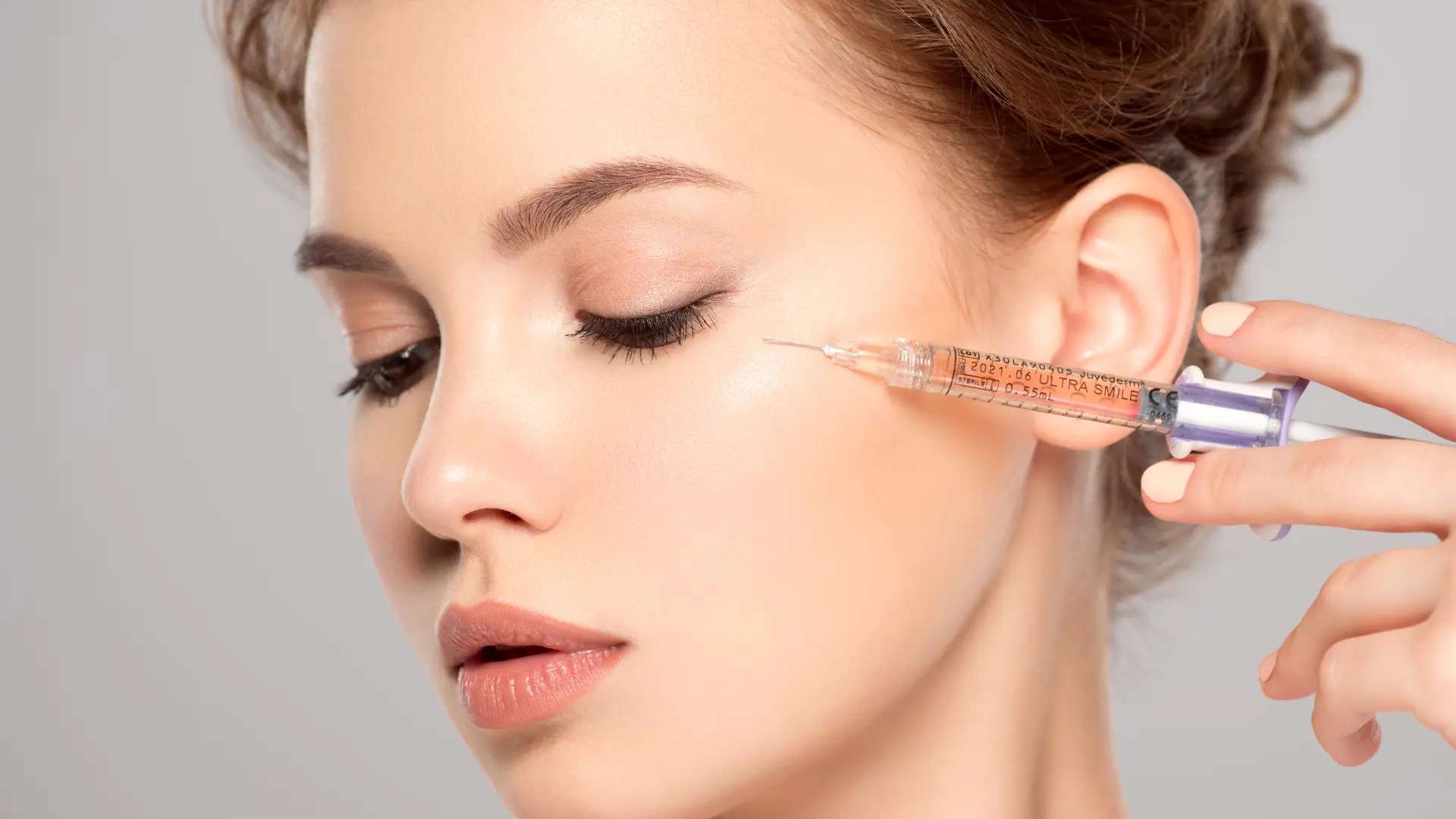 An individual receiving a collagen injection for their facial region.