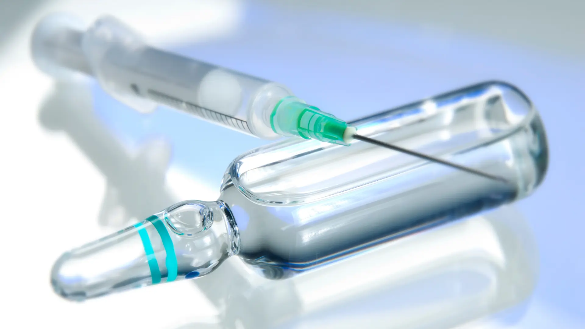 A close-up shot of a medical syringe and a solution vial.