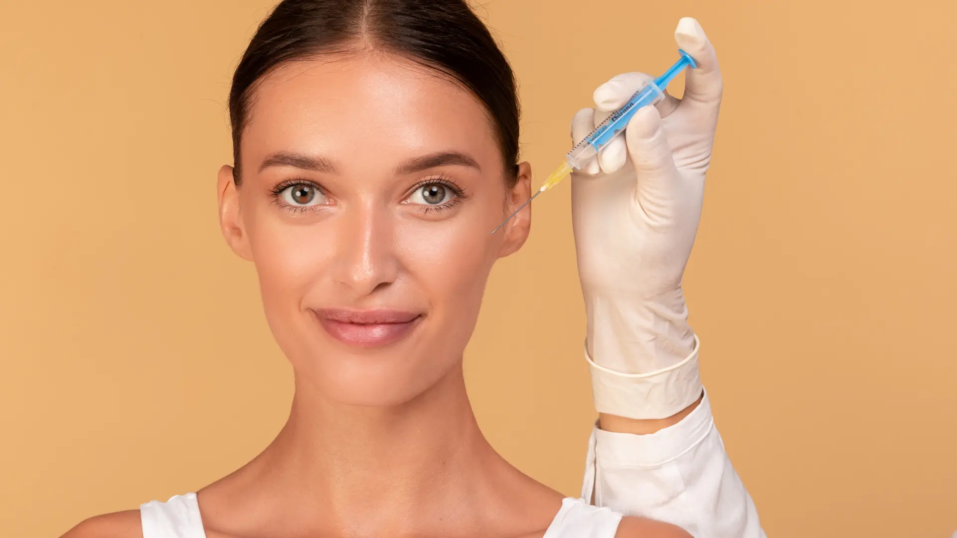 An individual preparing to receive a facial injection.
