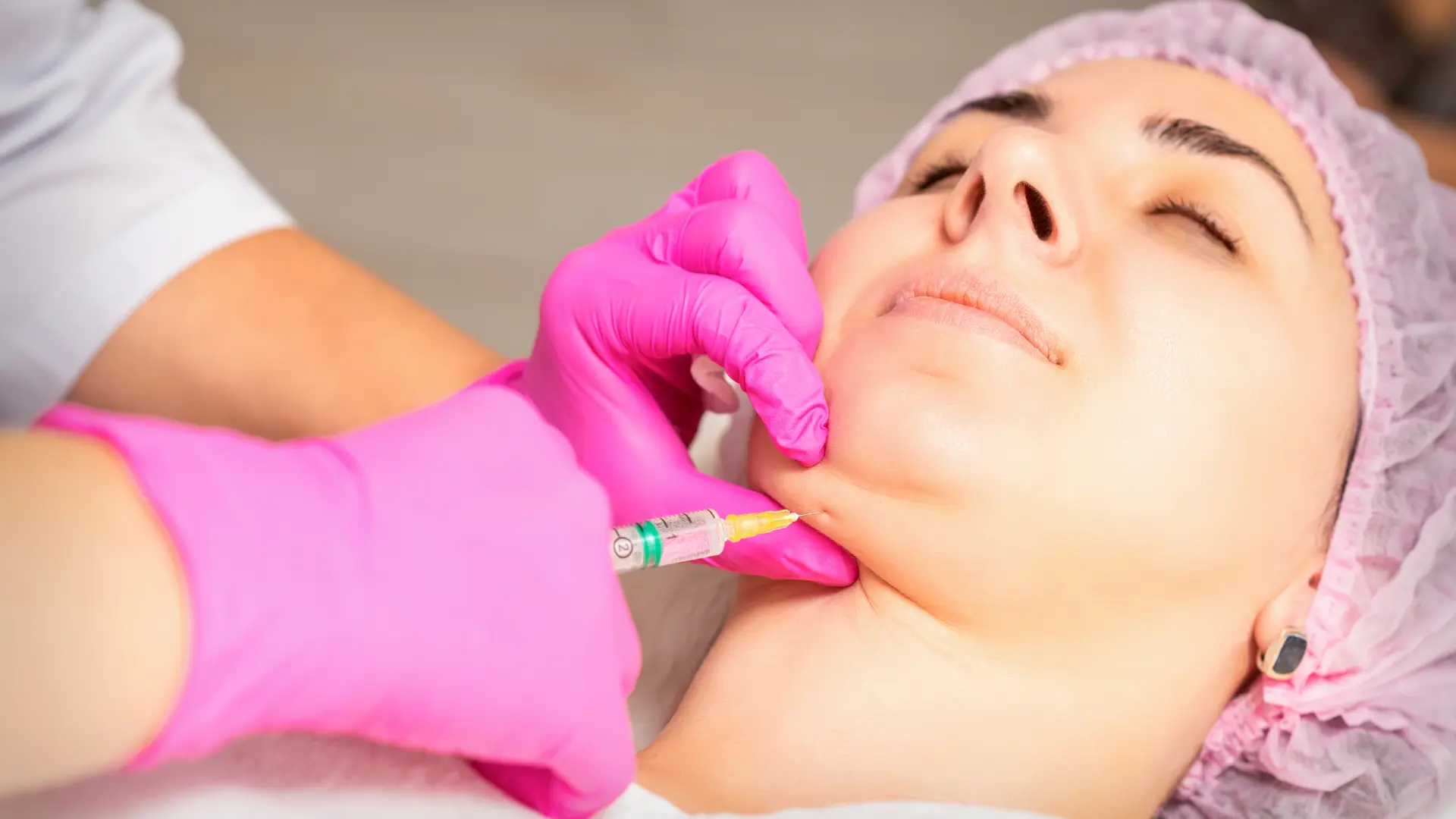 An individual receiving double chin injection for fat reduction.