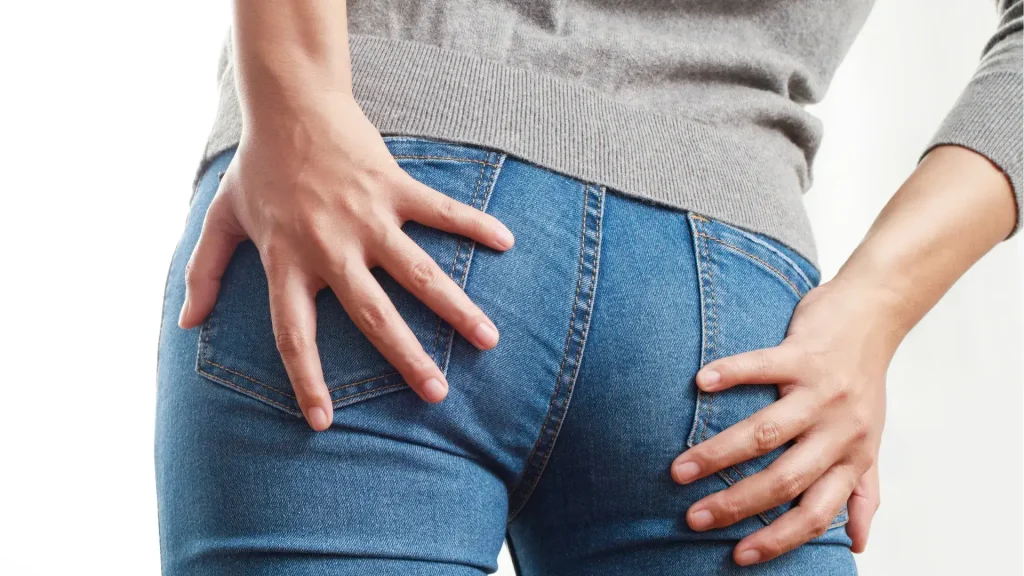 An individual flexing their fuller buttocks area.