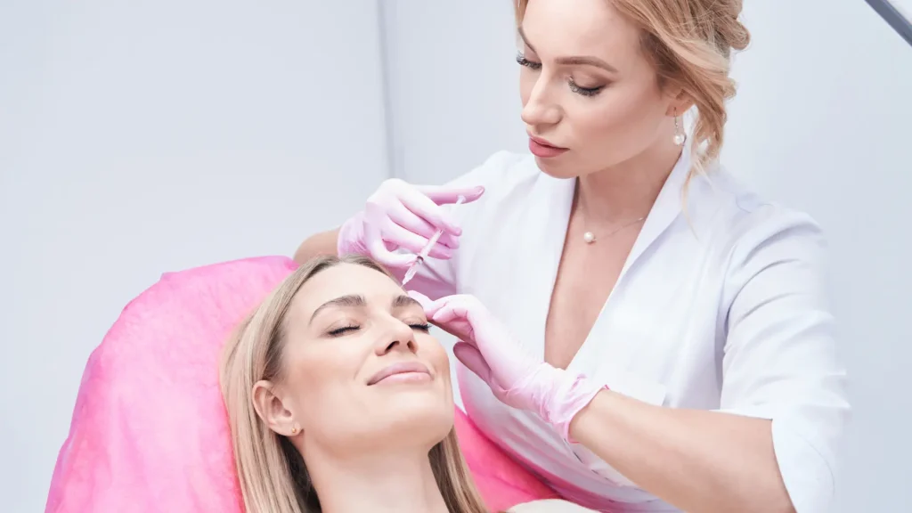 A patient receiving a dermal filler injection on their forehead.