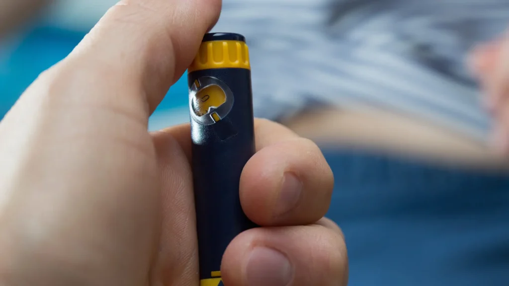 An individual administering their injectable pen dosage.