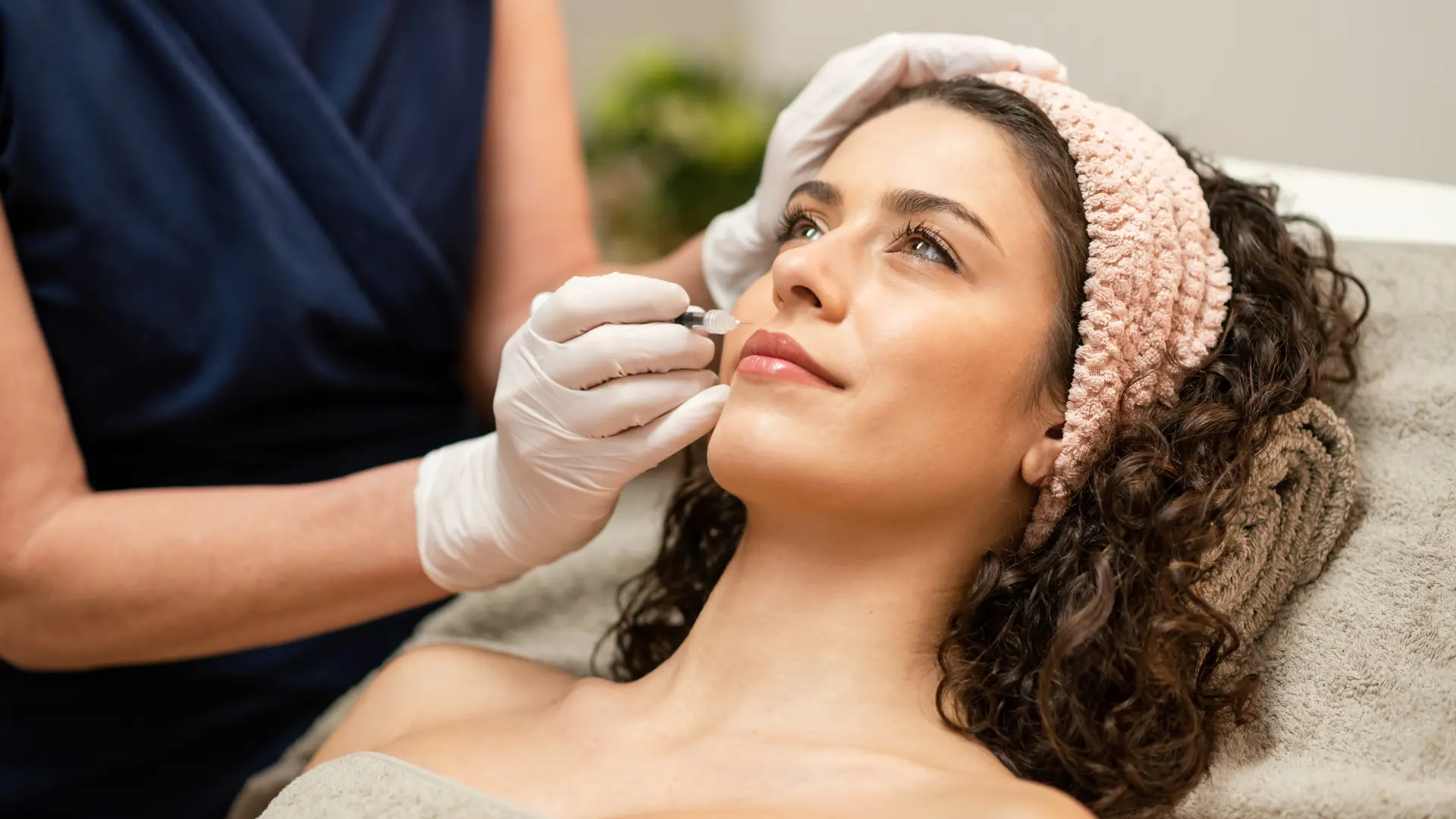 An individual receiving an injection into their facial region.