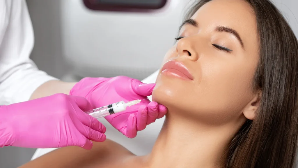 An individual receiving injection in their lower-face region.