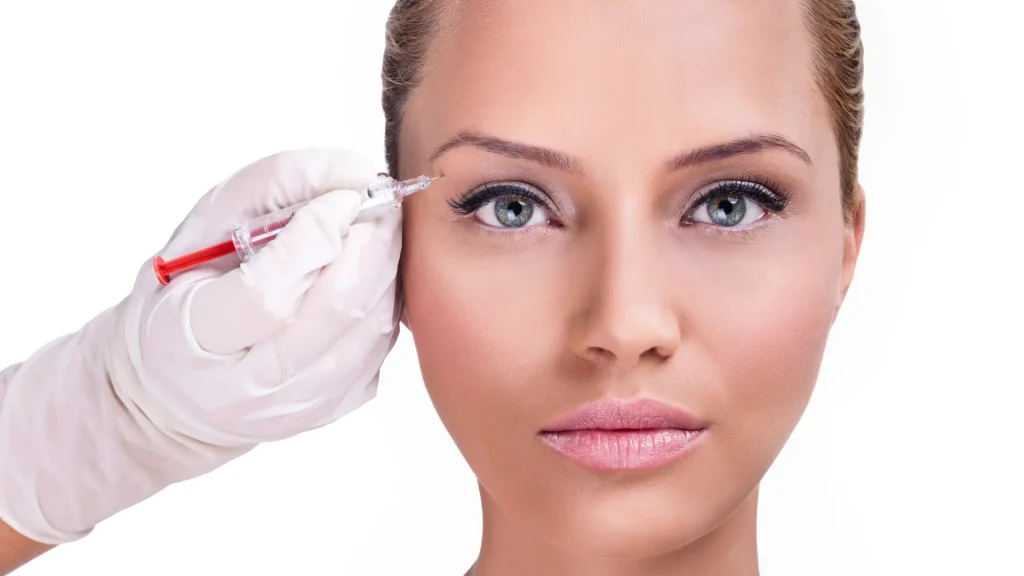 An individual receiving an injection into their eye area.