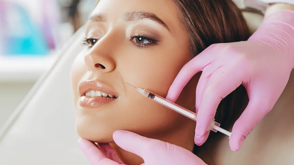 An individual receiving an injection for their nasolabial folds.