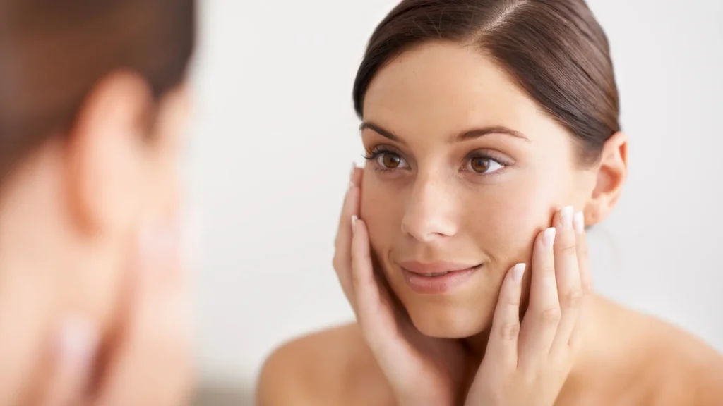 An individual looking into their smooth facial skin.
