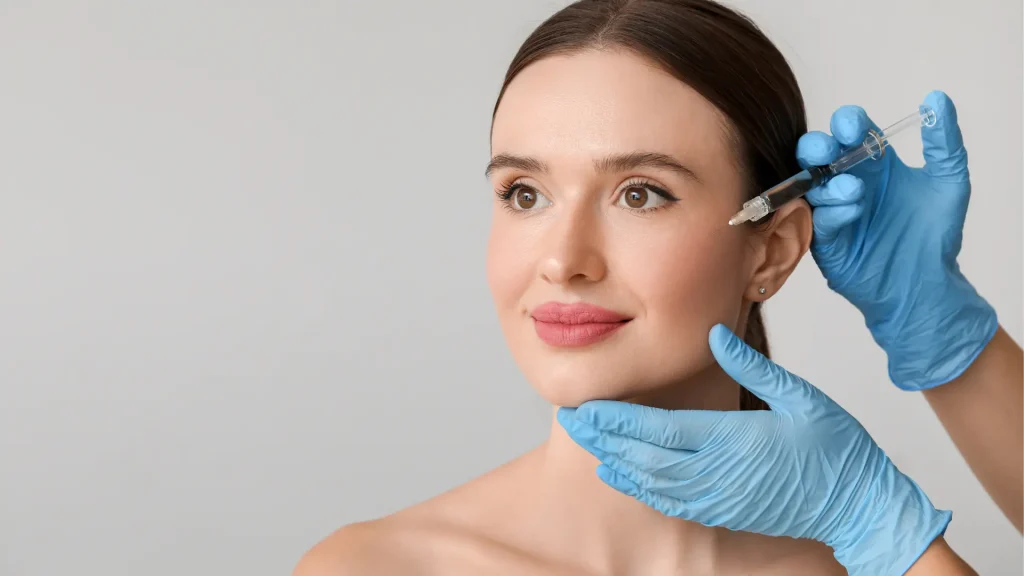 An individual receiving an injection near their eye region.