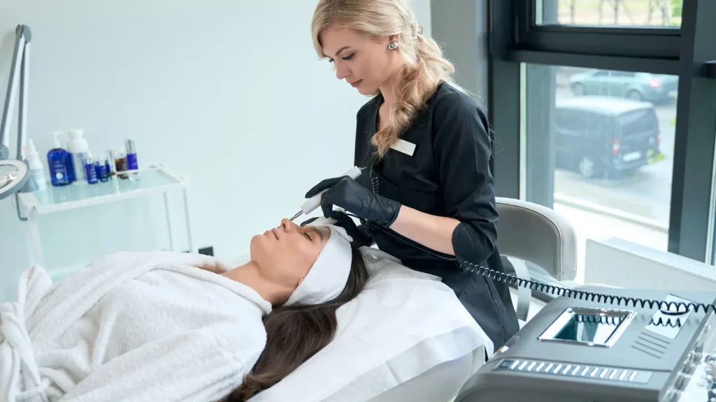 A medical professional examining a patient's facial region.