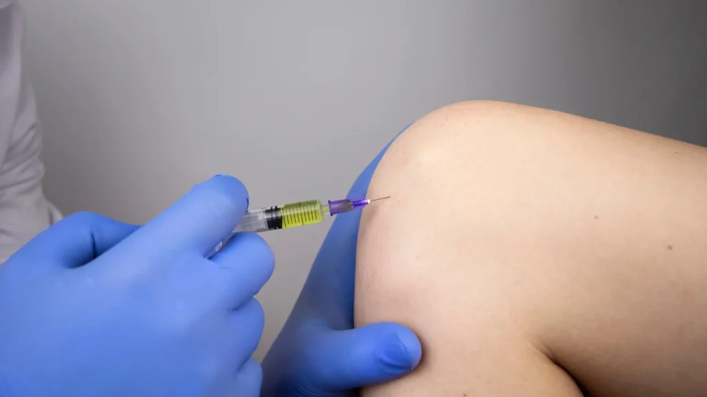 An individual receiving knee injection for their osteoarthritis condition.