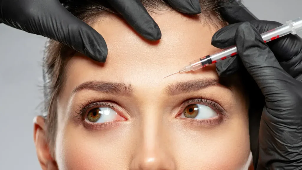 An individual receiving an injection on their forehead.