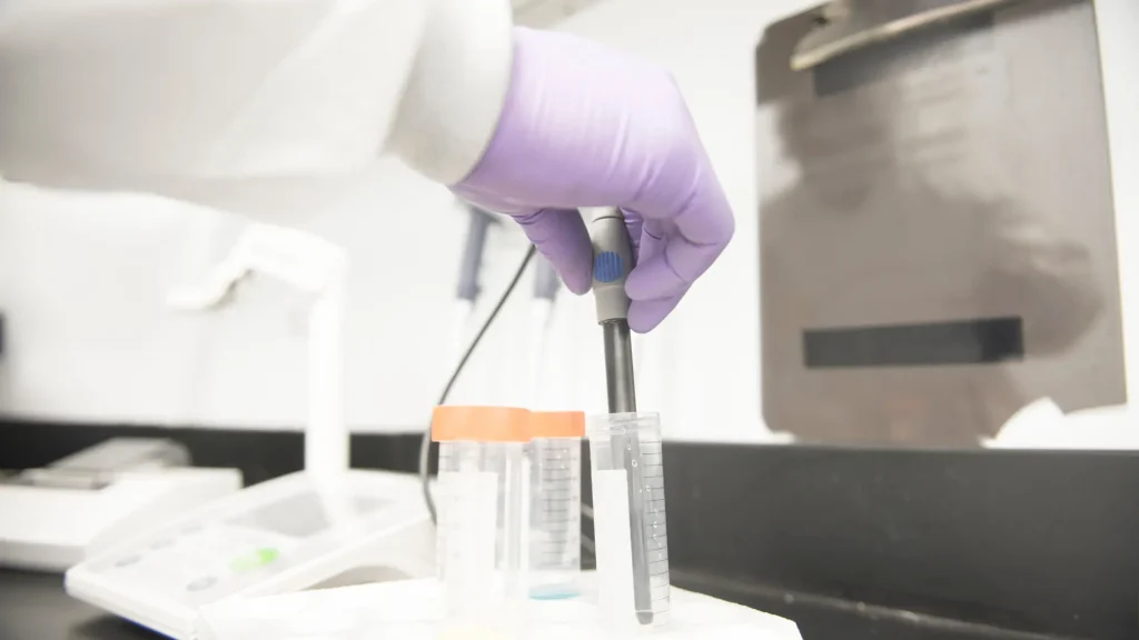 A medical expert in a laboratory, developing a formulation.