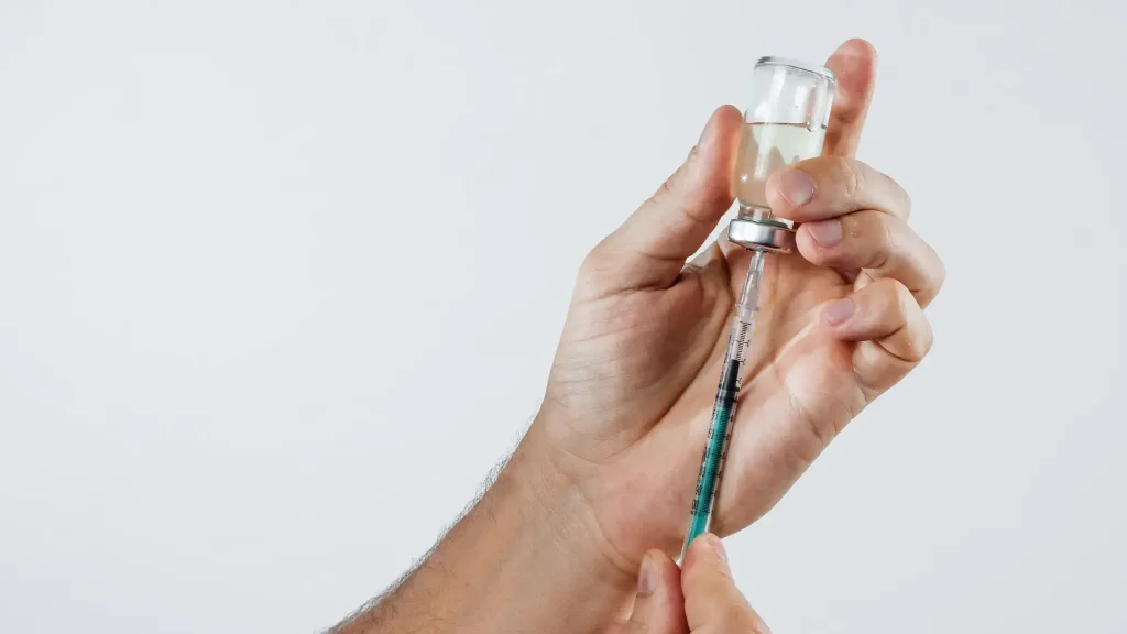 The process of transferring the solution into the syringe.