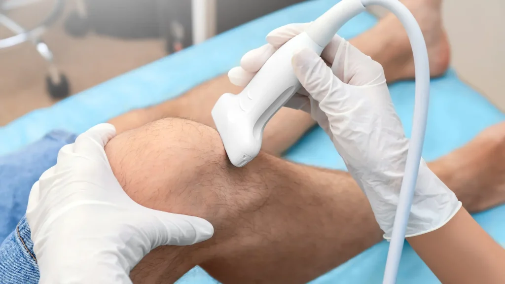 A patient's knee being examined by a medical professional.