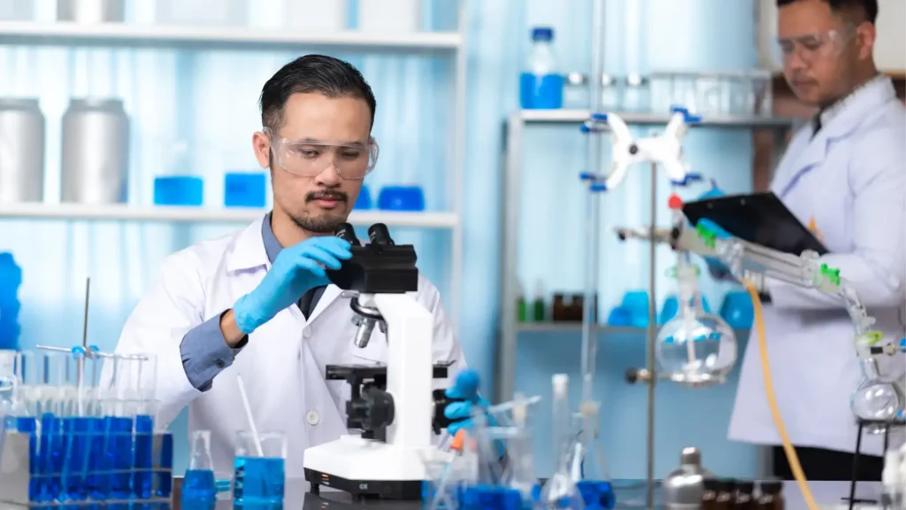 Medical experts examining formulations in a laboratory.