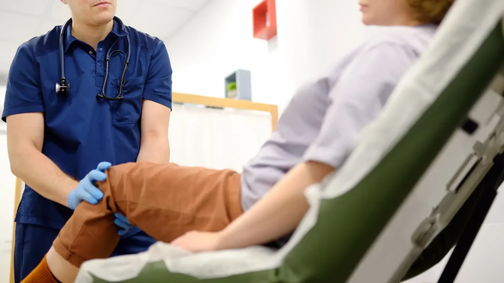 A medical professional examining a patient's joints.
