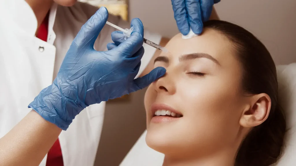 An individual undergoing an injection into their frown lines.