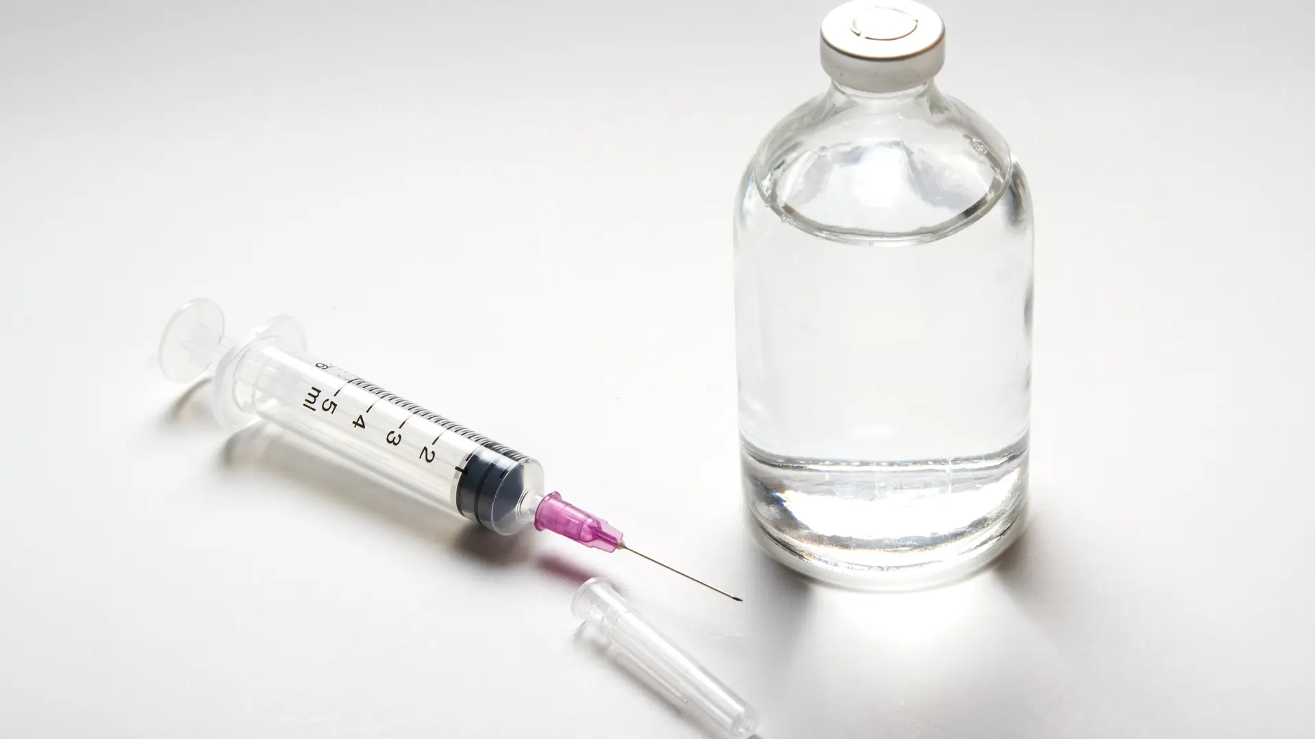 A close-up shot of medical syringe and vial.