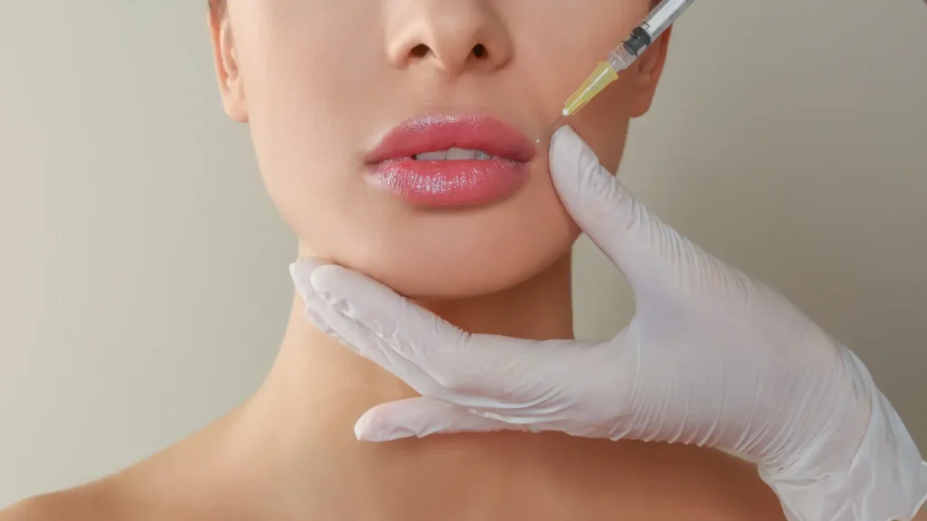 An individual receiving an injection into their upper lip region.
