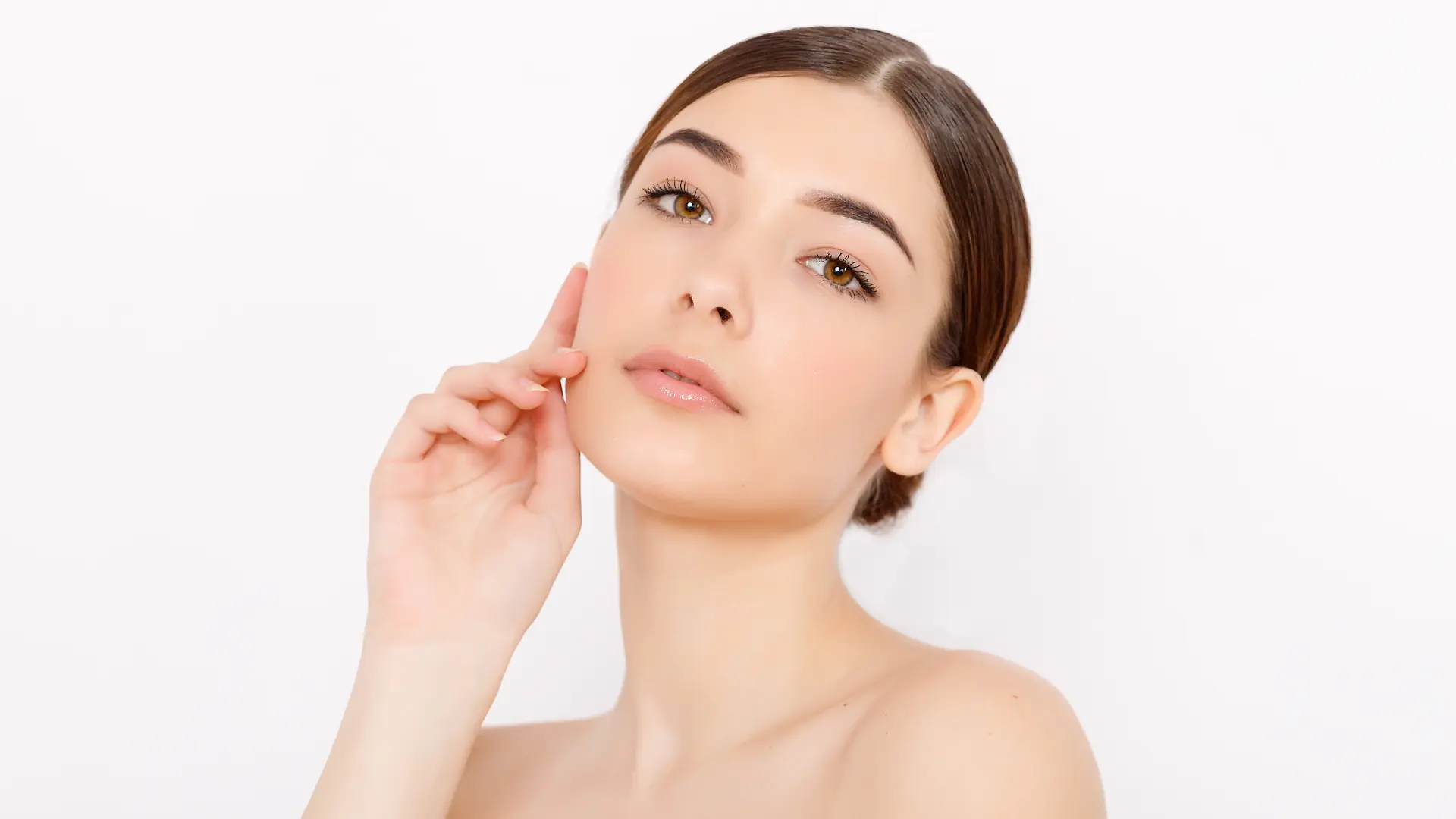 An individual showing their smooth and clear facial skin.