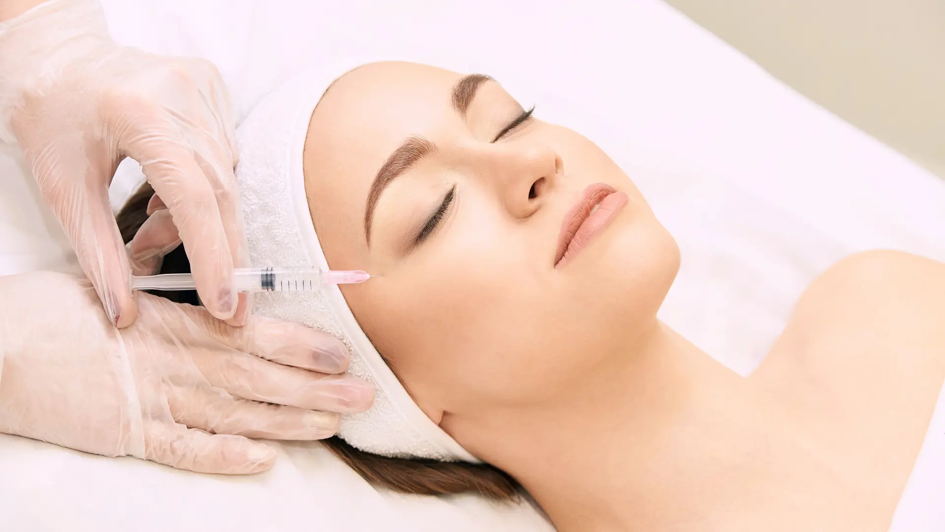 An individual receiving a facial injection near their eye region.