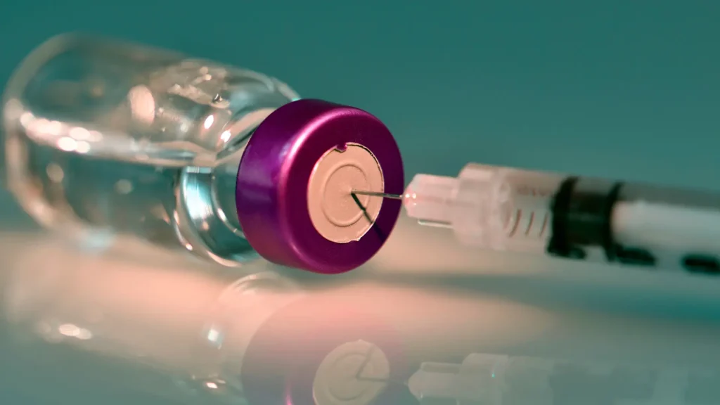 A close-up shot of a medical syringe and vial.