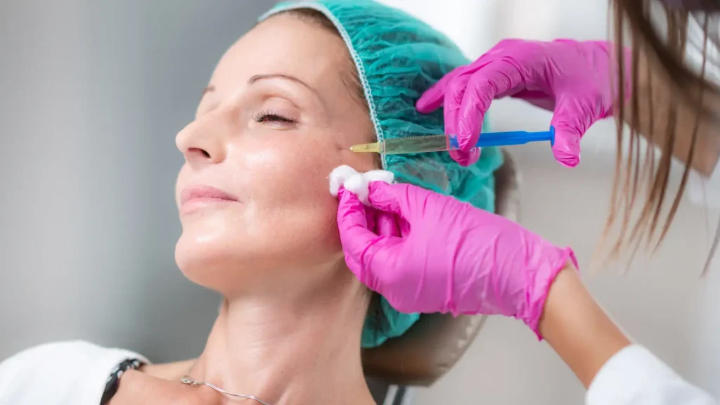 An individual receiving a facial injection from a medical professional.