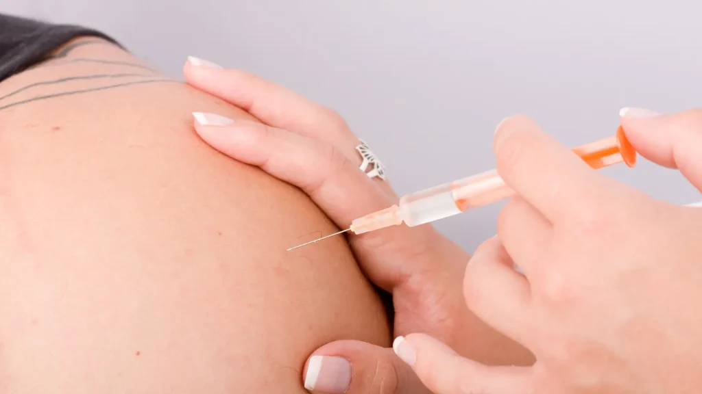 A medical provider administering a patient's shoulder.