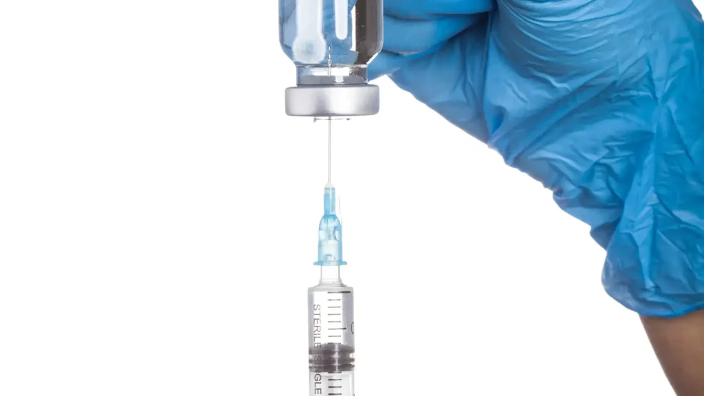 A medical professional preparing the injection solution.
