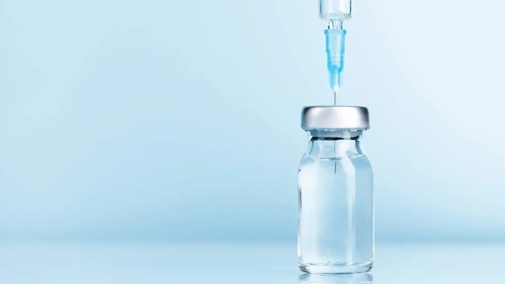 A medical syringe in a vial.