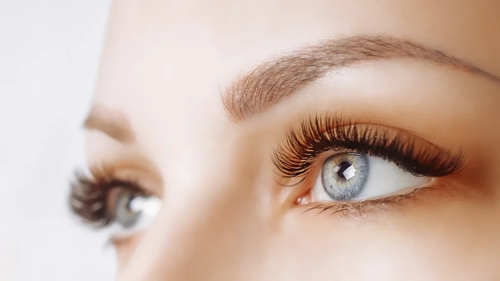 An individual with long and full eyelashes.