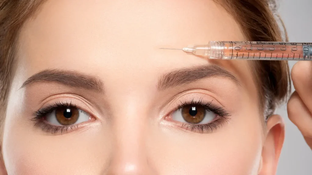 An individual undergoing a forehead injection.