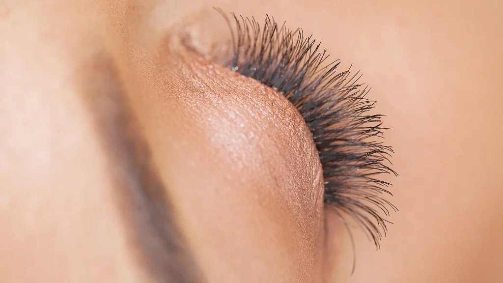 A close-up shot of an individual's long eyelashes.