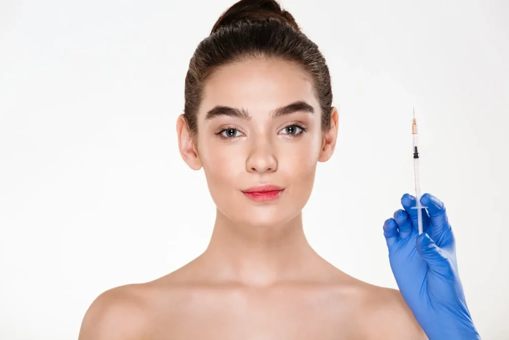 An individual preparing for injection in their facial area.