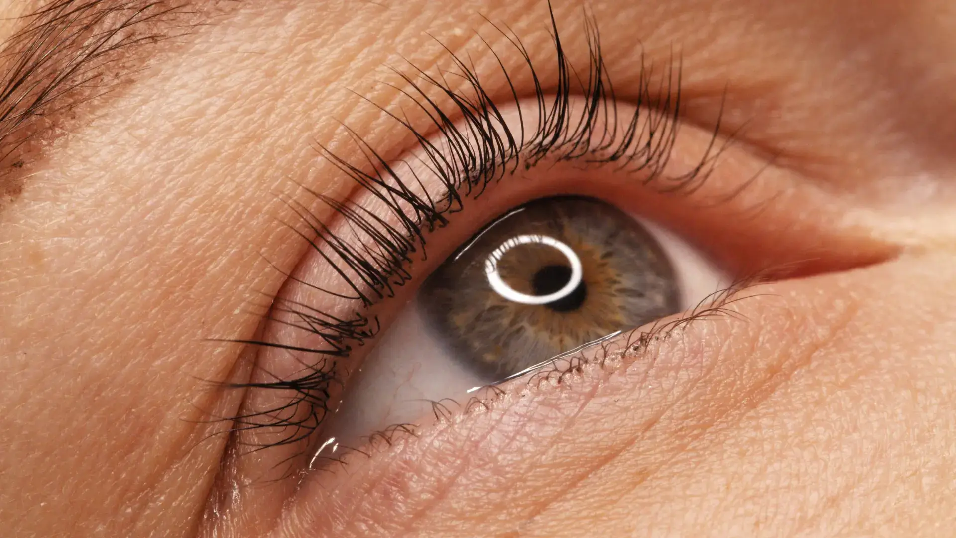 A close-up shot of an individual's eye area and lashes.