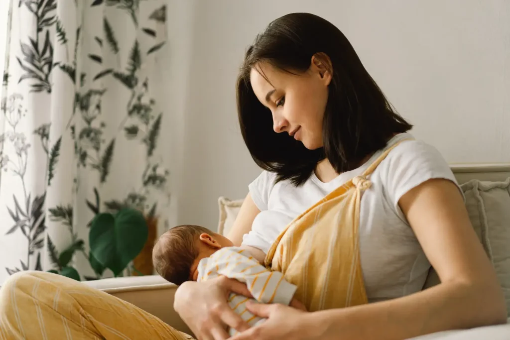 A mother breastfeeding her newborn child.