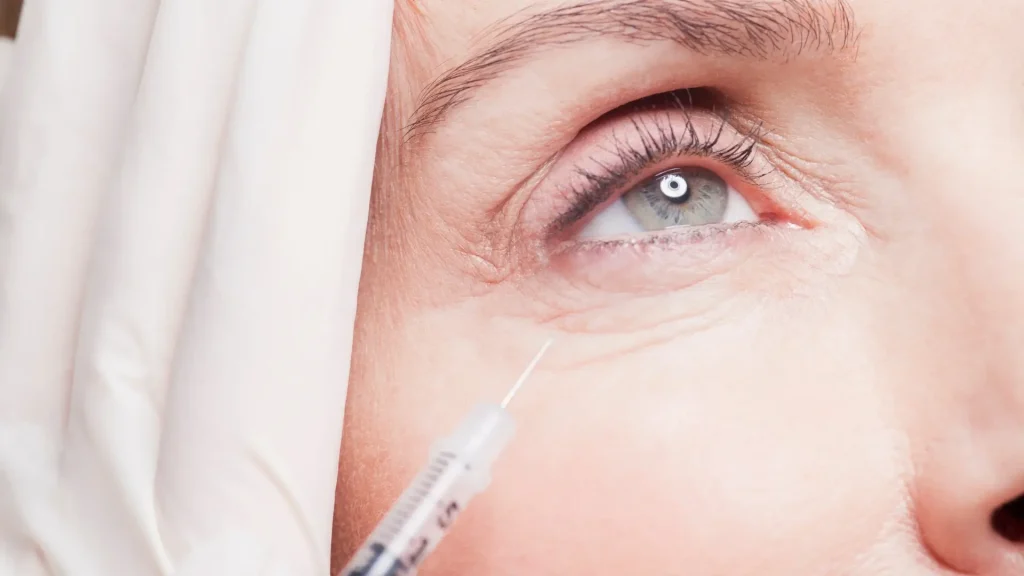 An individual receiving an injection for their under eye aging signs.